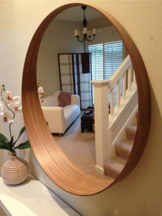 Wood framed mirror with widened frame